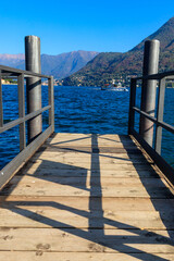 Fototapeta premium Wooden pier overlooking the Alps and Lake Como in Italy