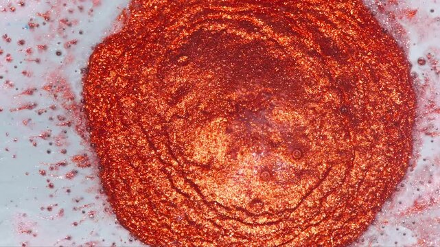 Macro Red Glitter Paint Splash In Liquid Bath With Shimmering Circular Abstract Texture