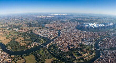 Obraz premium Breathtaking Aerial View of Picturesque European City by Serene Waterways and Snowy Mountains