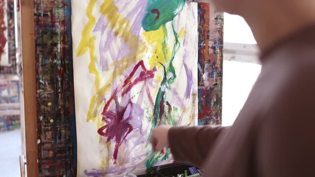 Female artist painting in her studio
