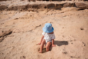 Toddler Exploring Rocky Beach and Natural Tide Pool &ndash; Childhood Curiosity Concept