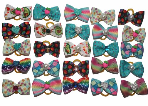 Set of decorative pet bows in bright colors with different prints, including hearts, fruits, and polka dots. Stylish grooming accessories for dogs, isolated on clean background.