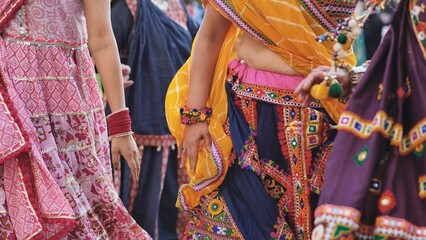 Naklejka premium Women dancing in traditional clothes celebrating Ganesh Chaturthi festival in India