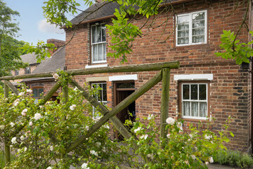 Charming English Brick Cottage With Rose Garden, Wooden Trellis and Lace-Curtained Windows