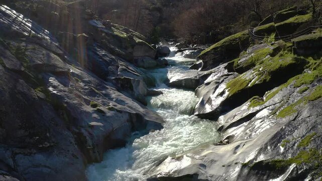 Aerial view of Los Pilones Bridge area in Garganta de los Infiernos, Spain. Exceptional river flow surging through granite formations in Jerte Valley, creating powerful whitewater and dramatic flood.