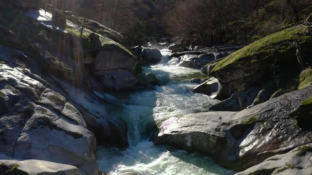 Aerial view of Los Pilones Bridge area in Garganta de los Infiernos, Spain. Exceptional river flow surging through granite formations in Jerte Valley, creating powerful whitewater and dramatic flood.