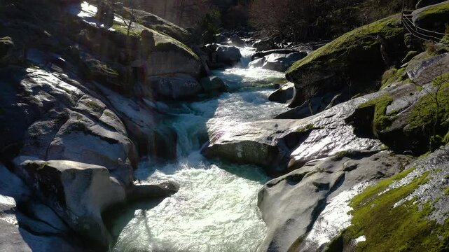 Aerial view of Los Pilones Bridge area in Garganta de los Infiernos, Spain. Exceptional river flow surging through granite formations in Jerte Valley, creating powerful whitewater and dramatic flood.