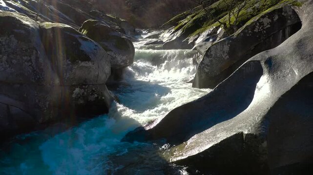 Aerial view of Los Pilones Bridge area in Garganta de los Infiernos, Spain. Exceptional river flow surging through granite formations in Jerte Valley, creating powerful whitewater and dramatic flood.
