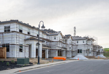 Fototapeta premium New Construction Homes Under Development in Suburban Residential Neighborhood, Housing Market Growth, Real Estate Development, and Modern Single Family Community Expansion