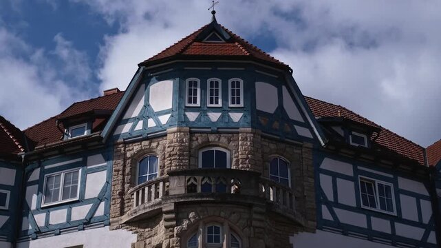 Half-timbered house with amazing blue timber frame in Meiningen, Thuringia - East Germany. Close-up slow motion of a traditional German building with balcony and beautiful facade. Panning street view.