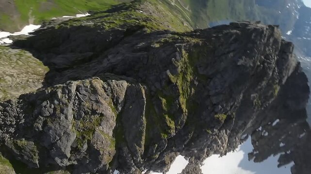 Cinematic Aerial Shot of Sharp Jagged Mountain Peak wth Snow Patches