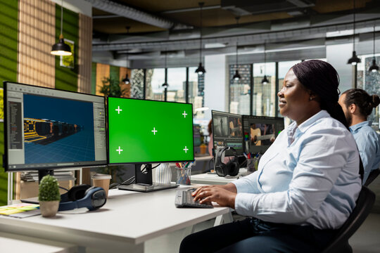 Chroma key mockup and space themed video game interface, using programming software and modern development tools. Woman creating virtual world environments for the gaming industry.