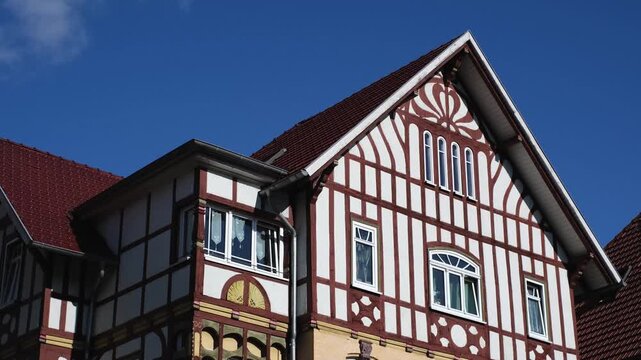 Half-timbered house in Meiningen, Thuringia - East Germany. Close-up slow motion of a traditional German building with detailed windows and facade. Panning street view.