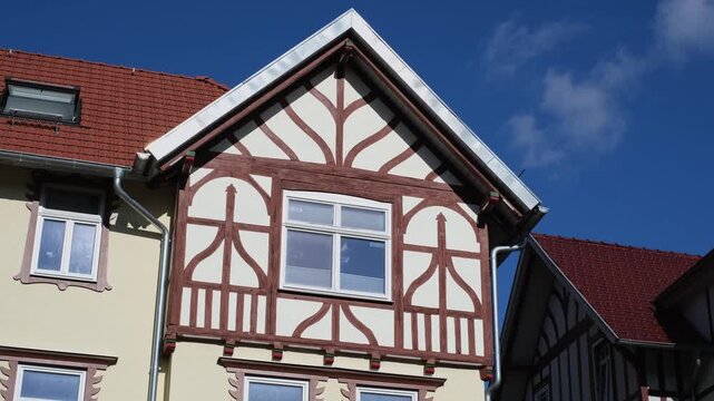 Half-timbered houses in Meiningen, Thuringia - East Germany. Close-up slow motion of a traditional German building with detailed windows and facade. Look up panning street view.