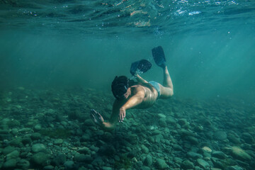 Man snorkeling and swimming underwater © Mulderphoto