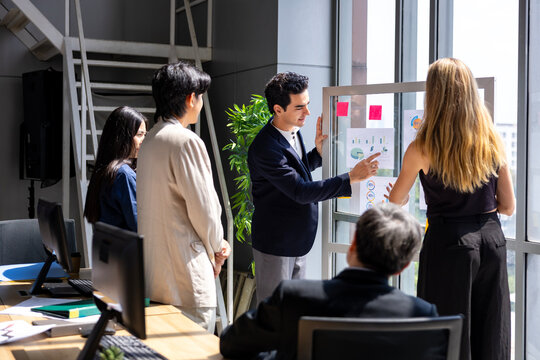 Team of young caucasian entrepreneur have small team meeting for project for marketing and sale management with skyscraper view for business startup and education