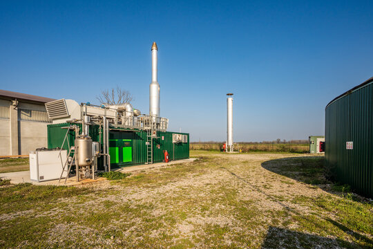 Agricultural biogas plant with cogeneration unit and anaerobic digester dome.