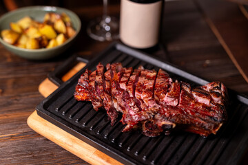 Sliced beef steak cast iron skillet restaurant brasserie grilled potatoes wine rustic dinner medium...