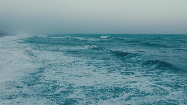 Low passage in a sad and furious stormy ocean waves crash repetitively