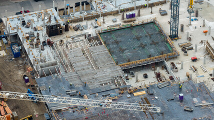 Aerial View Concrete Construction Site with Workers and Tower Crane in Mueller © Greyline Visual