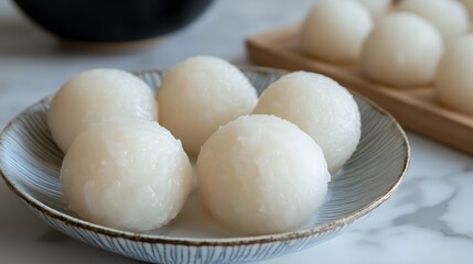 Fototapeta premium Soft white mochi ice cream balls on a striped ceramic plate