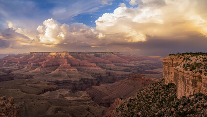 Grand canyon vista at golden hour with dramatic clouds and layered canyon rock formations