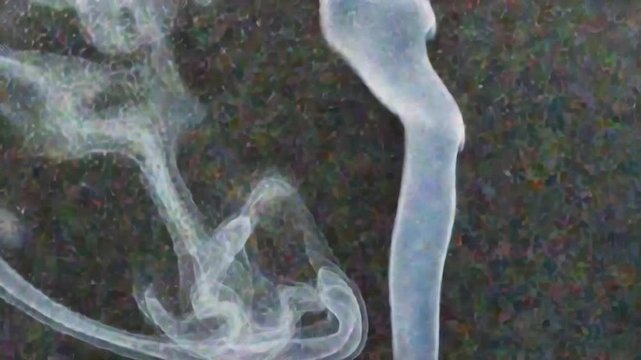 Smoke swirling in the air against a dark background with a moody atmosphere and a sense of movement and fluidity