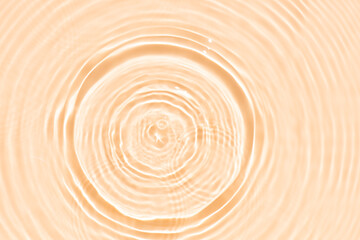 Orange water bubbles on the surface ripples. Defocus blurred transparent pink colored clear calm...
