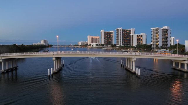 Aerial drone flying over bridge at dusk above florida intracoastal waterway
