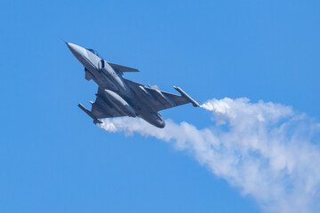 Military Fighter Jet Performing Aerobatic Flight Maneuver
