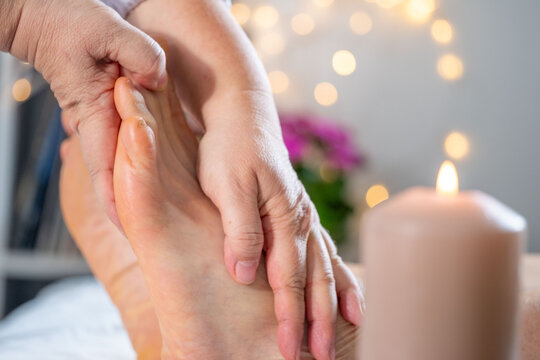 Foot orthopedic massage in progress, Therapist's hands massaging an elderly man&rsquo;s Foot, holistic body care, pampering and rejuvenation