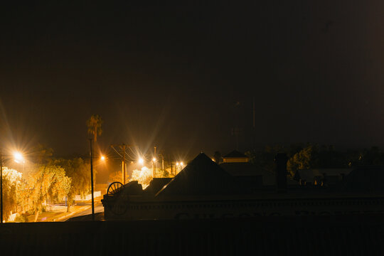 Vibrant streetlights lining quiet street at night time