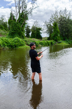 Happy person fishing reeling in catch