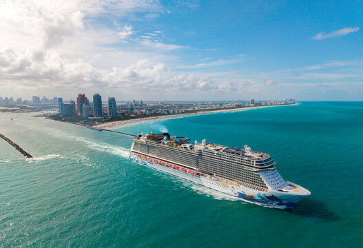 Miami, Florida, USA - May 11, 2025: Norwegian Escape cruise ship voyage. Cruise in summer vacation. NCL. Norwegian cruise line. Cruise ship tour and travel at sea. Ship leaving Miami beach port