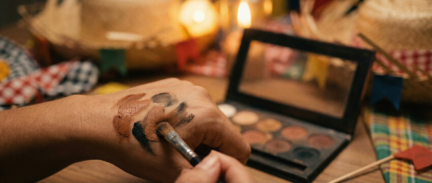 A person applying makeup with a brush on their arm