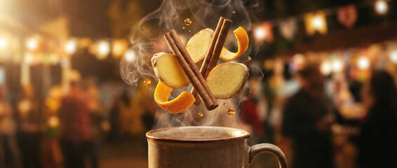 Fototapeta premium A cup of coffee with cinnamon sticks and orange slices floating in the air