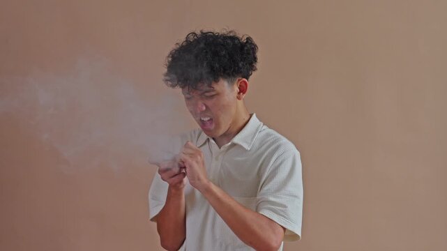 Asian man experiencing asthma attack or chest pain due to secondhand smoke