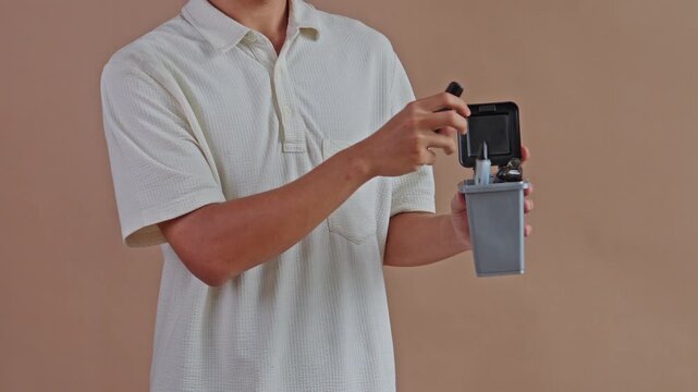 Close up of hands putting vaping equipment and lighter into trash can