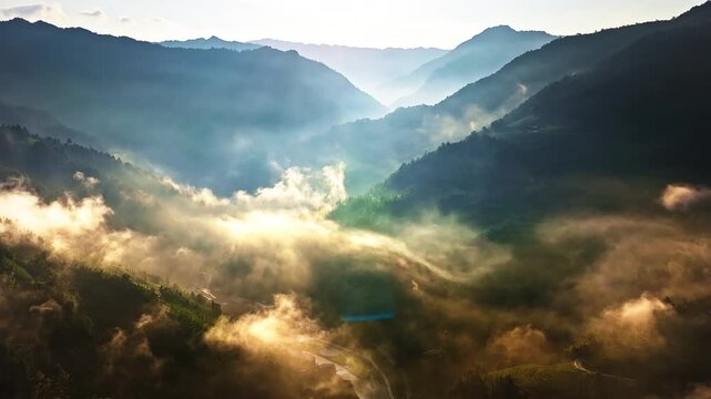 Majestic sunbeams and light rays illuminating morning mist in a deep mountain valley, Guilin, China.