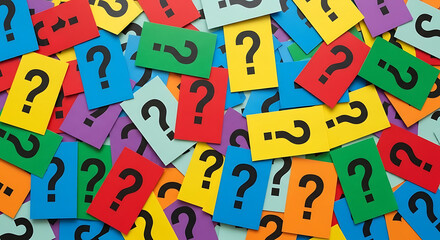 A pile of colorful question mark cards scattered on a table