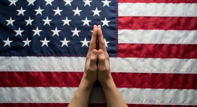 Praying hands in front of american flag with united states