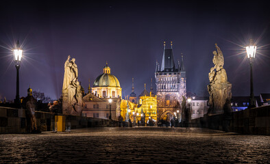 Charles Bridge statues at night with Prague Castle skyline, Czech Republic