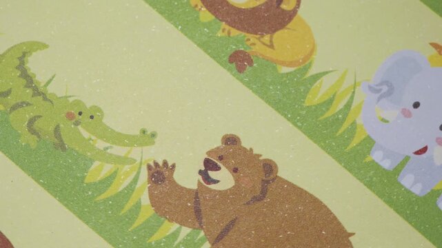 Top view of rotating wild animal pattern in motion on textured paper, Dynamic cartoon animal pattern for childhood and educational video concepts