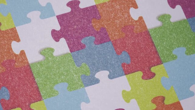 Colorful puzzle pieces arranged in a vibrant and playful pattern