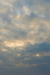 Fototapeta premium Cloud Layers Cast Luminous Beams. Vertical Atmospheric View With Radiant Sunlight Piercing Through Clouds