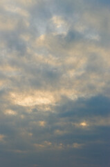 Fototapeta premium Cloud Layers Cast Luminous Beams. Vertical Atmospheric View With Radiant Sunlight Piercing Through Clouds