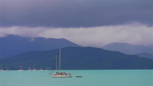 Sailboat Port of Airlie beach Coral Sea Marina boat ride cruise Great Barrier Reef Whitsunday islands Australia Queensland Hamilton Island Heart of the Reef coastline cloudy rainy afternoon sunset pan