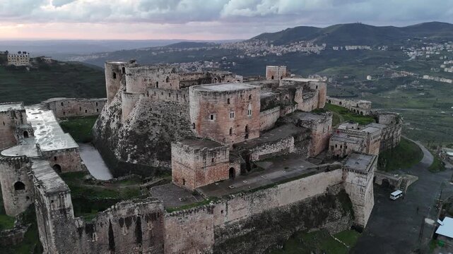 aerial perspective of the UNESCO-listed Krak des Chevaliers, capturing the preserved fortifications and strategic mountain landscape of the Syrian castle