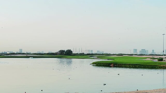 Golf course Night View, Water Pool in middle of Golf course with fresh green grass, smooth Fairways, plants, gentle sunlight creating peaceful players environment. 
Night View of AL Zorah Ajman Golf