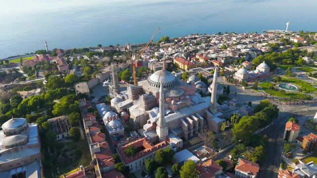 Istanbul, Turkey. Drone flyaway from Hagia Sophia to panoramic view with Blue Mosque and Sultanahmet Square rooftops and sea. Aerial View, Departure of the camera